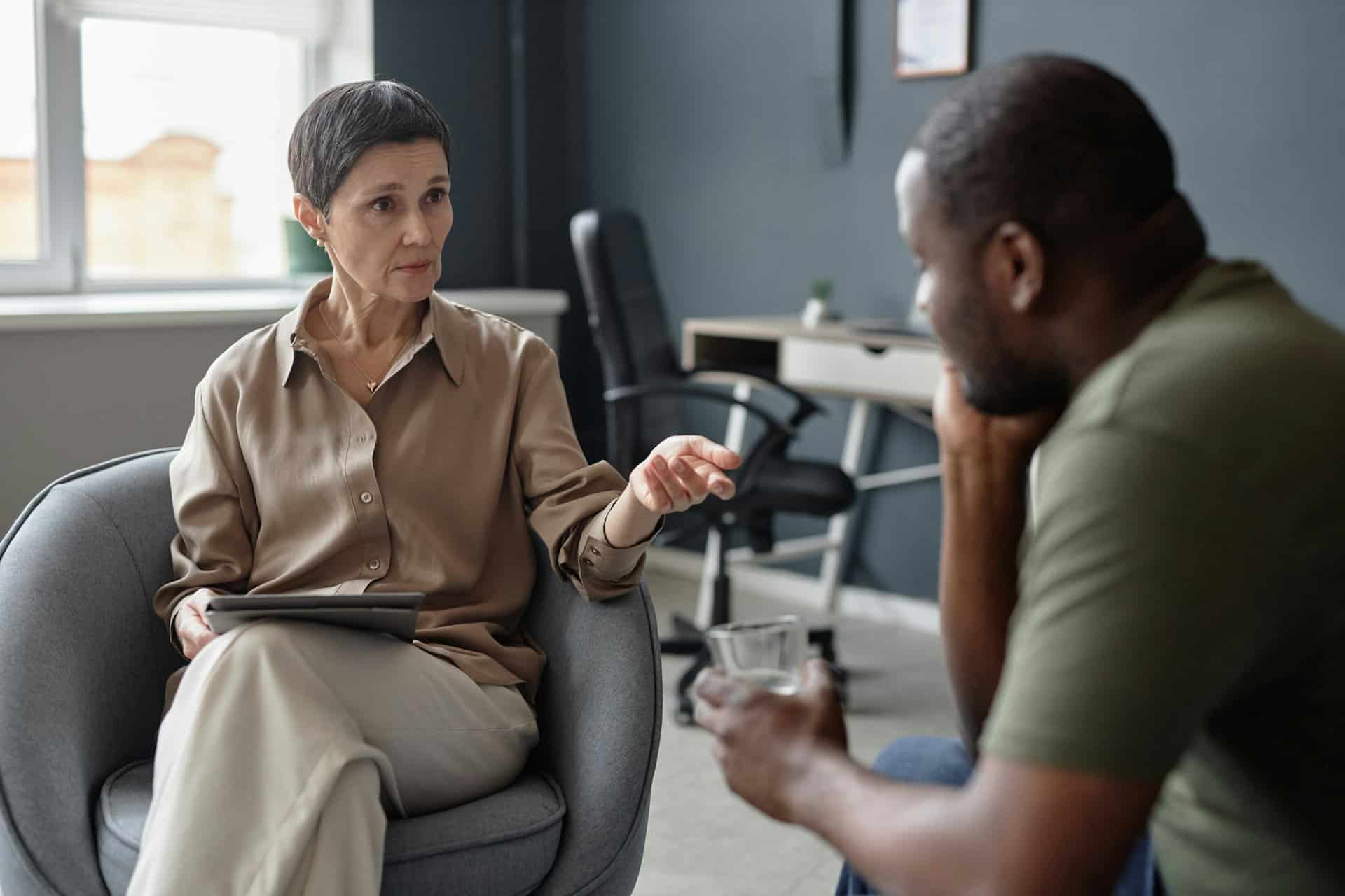 Adult Woman Consulting Black Man in Therapy Session