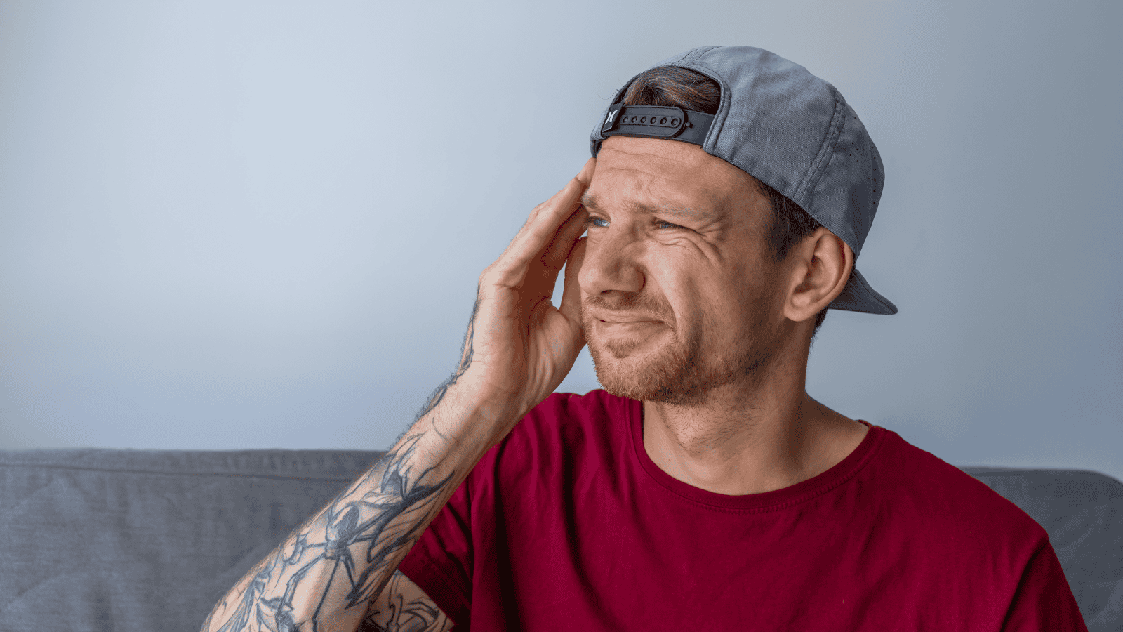 A stressed man with ADHD is struggling to focus